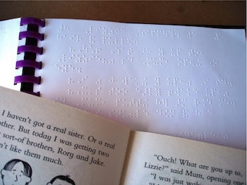 A braille book alongside a Roald Dahl book